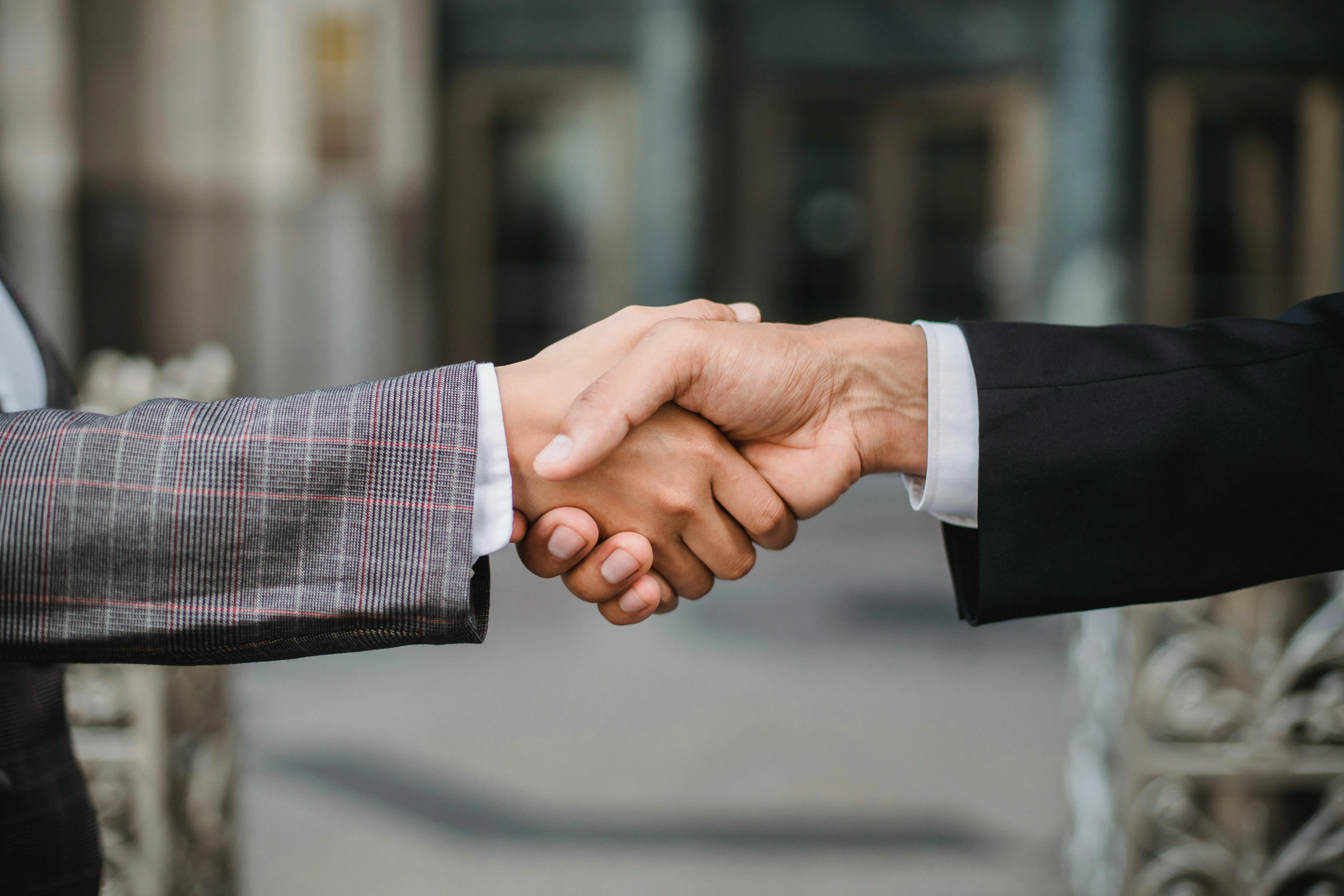 Two business representatives agreeing an international payroll services engagement covering UAE and overseas entities
