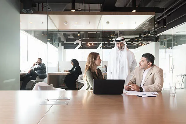 UAE payroll team running WPS salary file processing with bank-side acknowledgement screens visible on the workstation