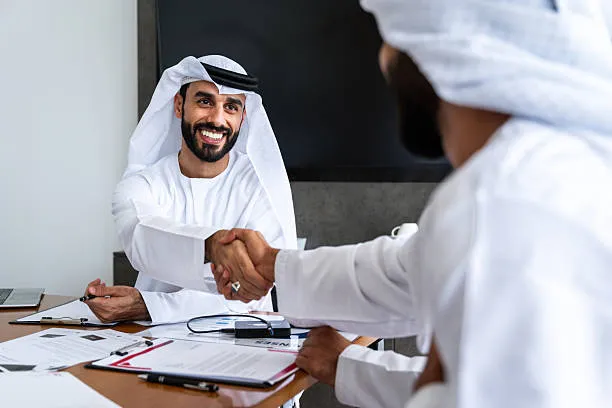 UAE professional reviewing employment offer letter, work permit application and ICP residency visa documents at a Dubai business hub before lodging through tasheel.ae