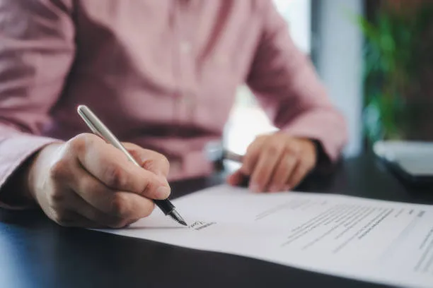 UAE qualified accountant ACCA CA CPA reviewing monthly management accounts and VAT-201 workpapers for a Dubai SME at a desk