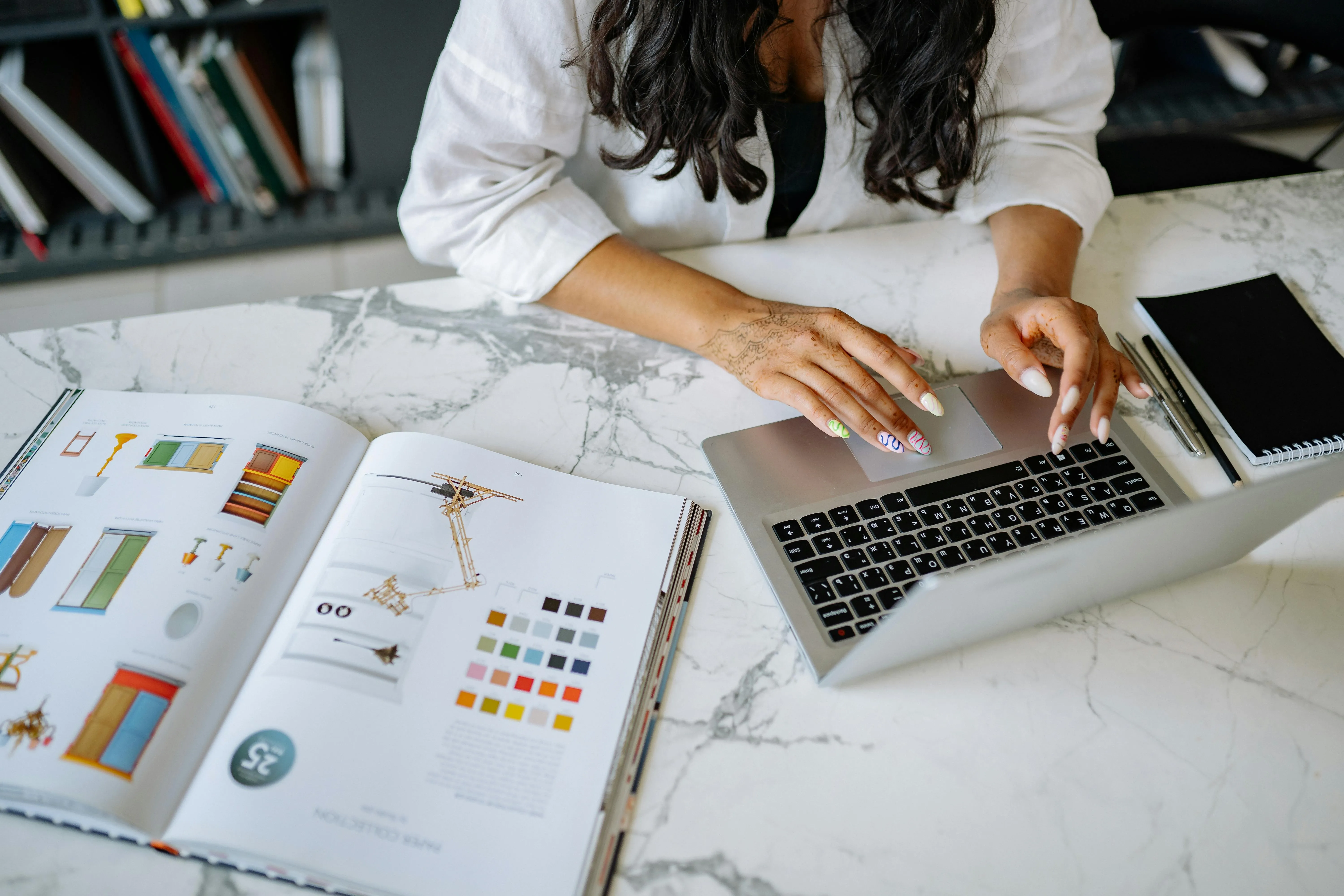 UAE accountant reviewing month-end accruals, prepayments and depreciation schedules against a bookkeeper's posted ledger