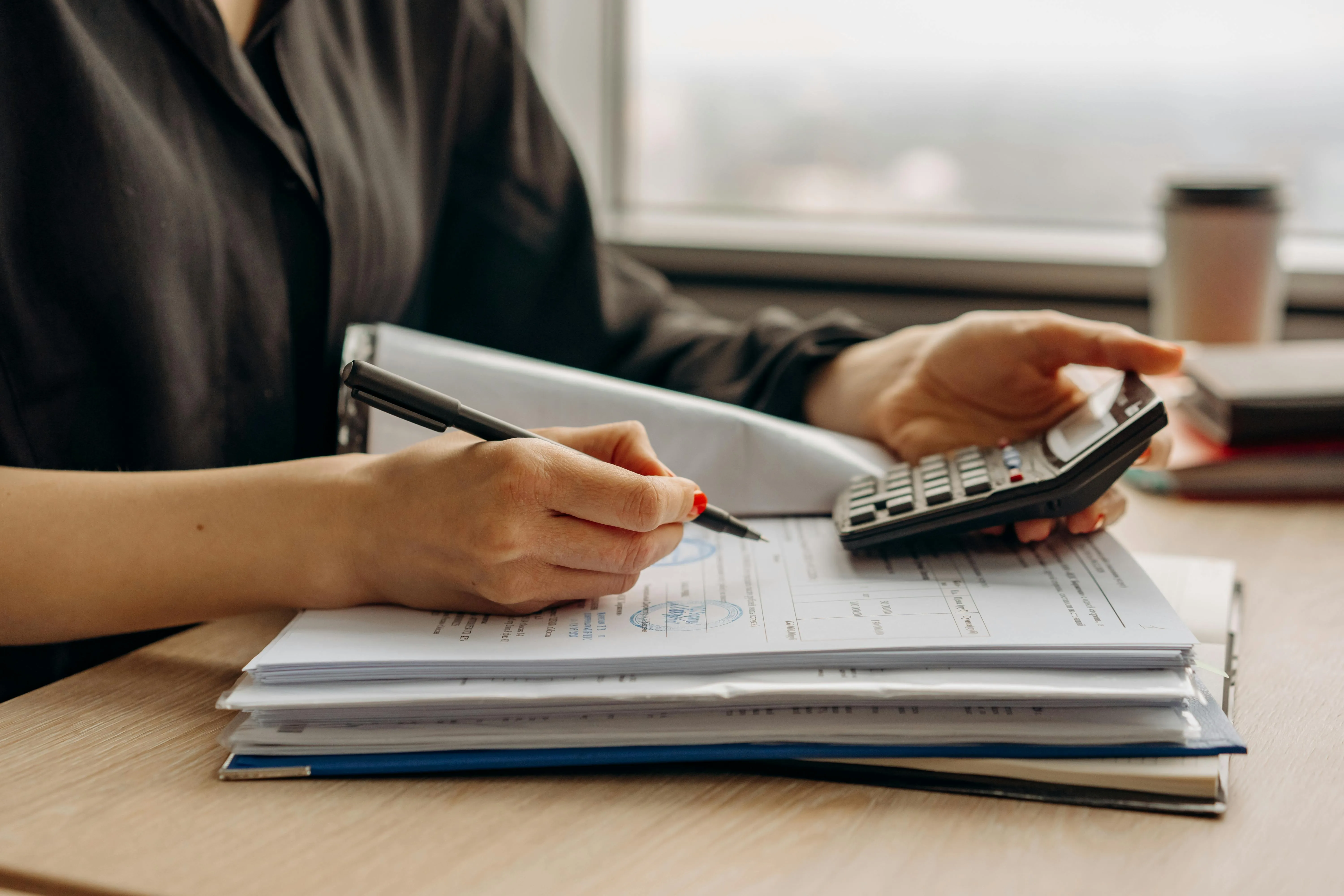 Cost model spreadsheet flagging UAE-specific lines such as Ejari, immigration card and bank guarantee fees inside a feasibility study working paper