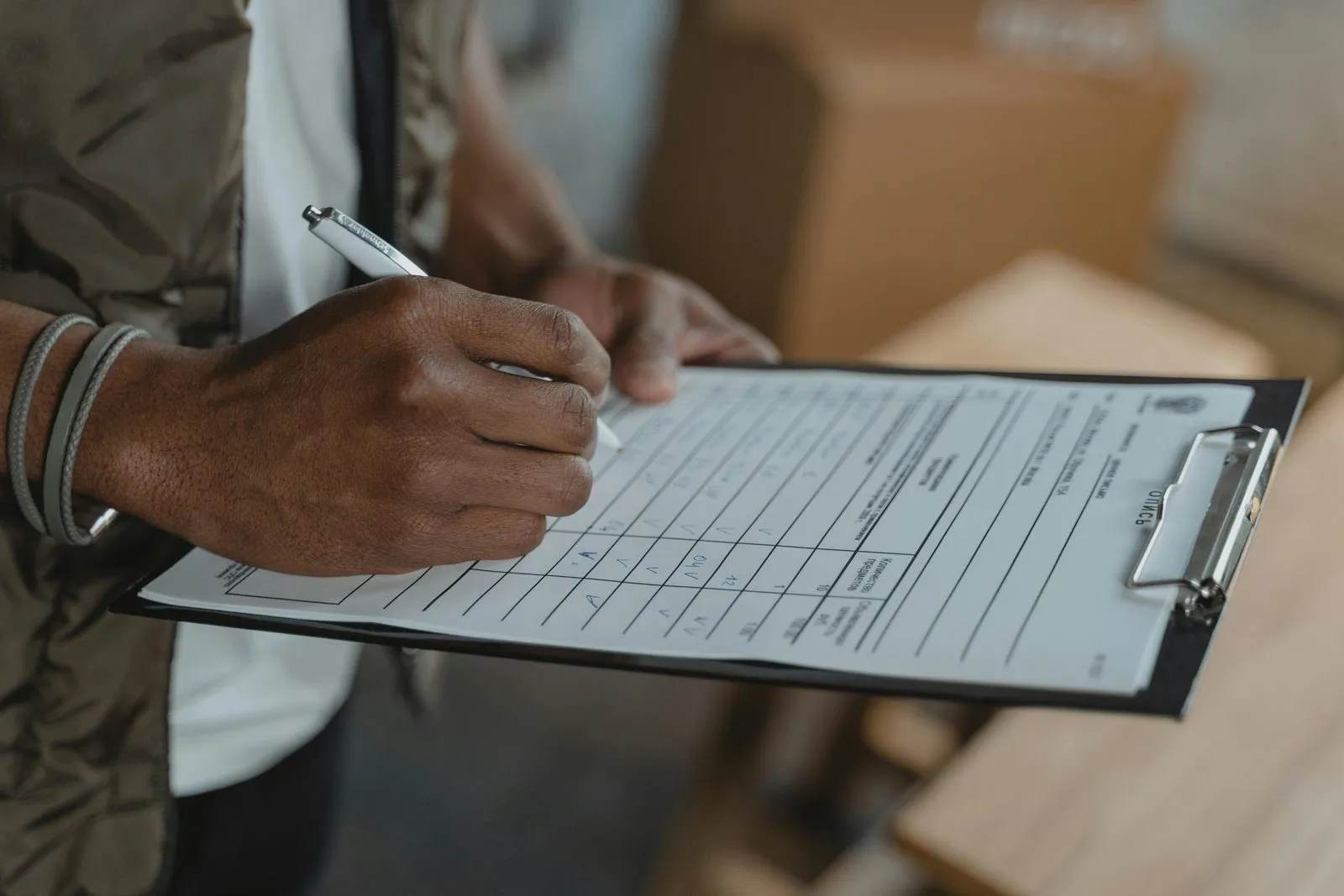 Ministry of Economy approved-auditor registration and a free zone authority's audit firm list being cross-checked side by side for a UAE company