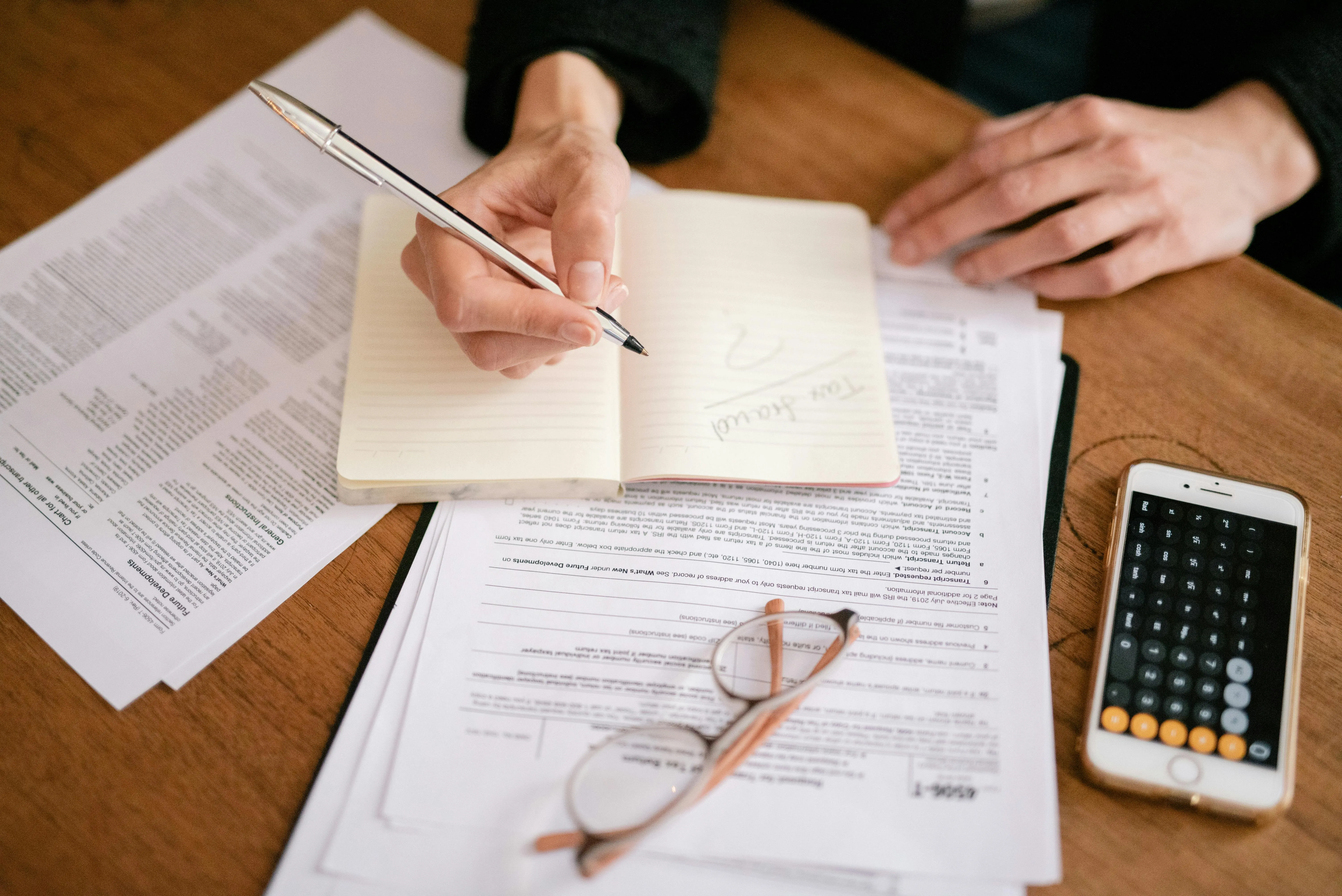 Notebook listing common reasons UAE businesses contact the FTA including registration support, penalty waivers and refund queries