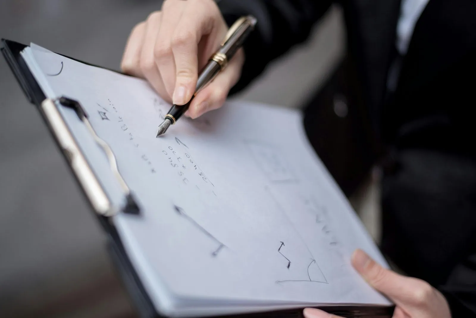 Auditor cross-checking bank confirmations and sales invoices against the general ledger during UAE year-end substantive testing