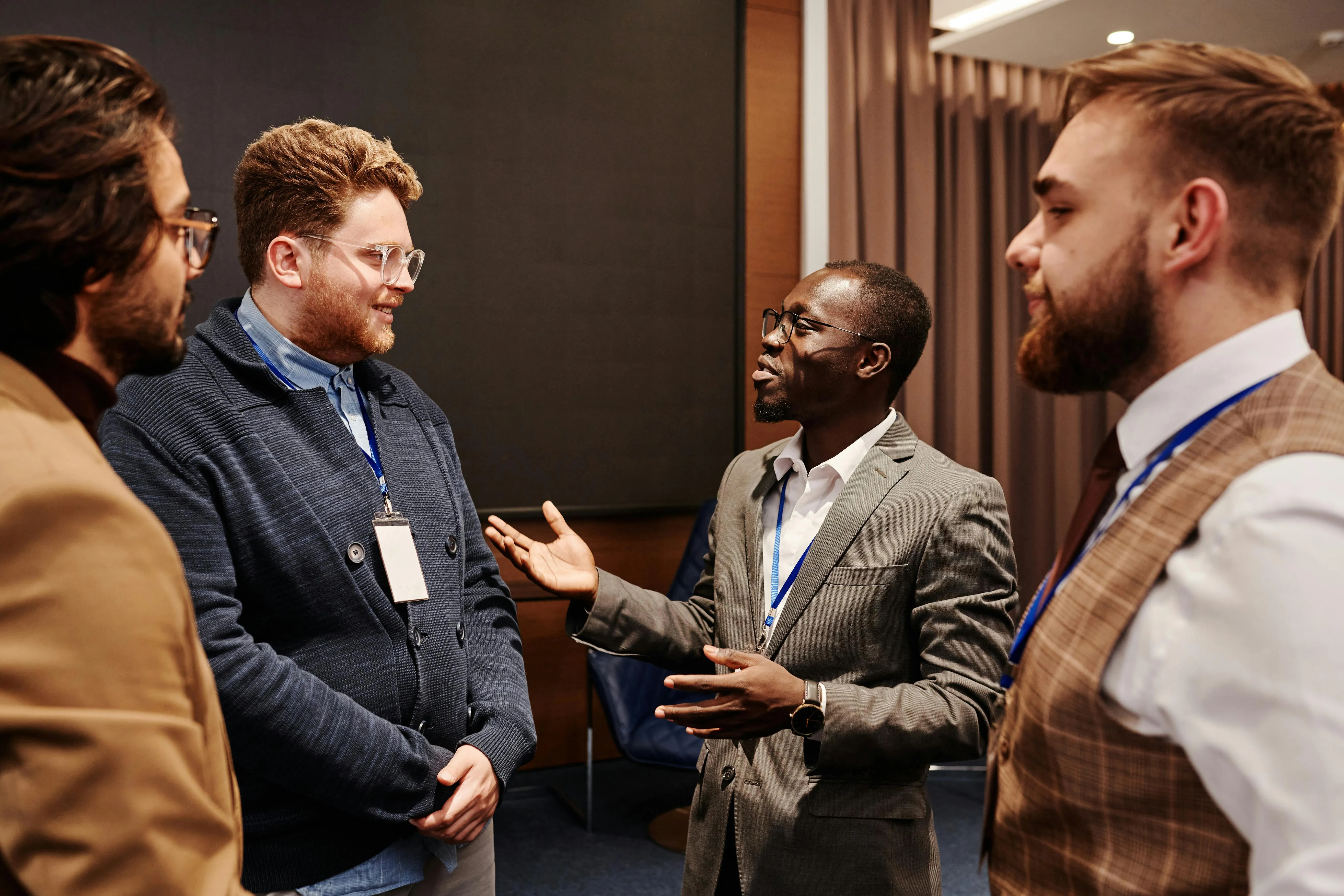 Finance professionals discussing reporting requirements at a UAE business event, the kind of conversation where the difference between financial, management and tax accounting matters