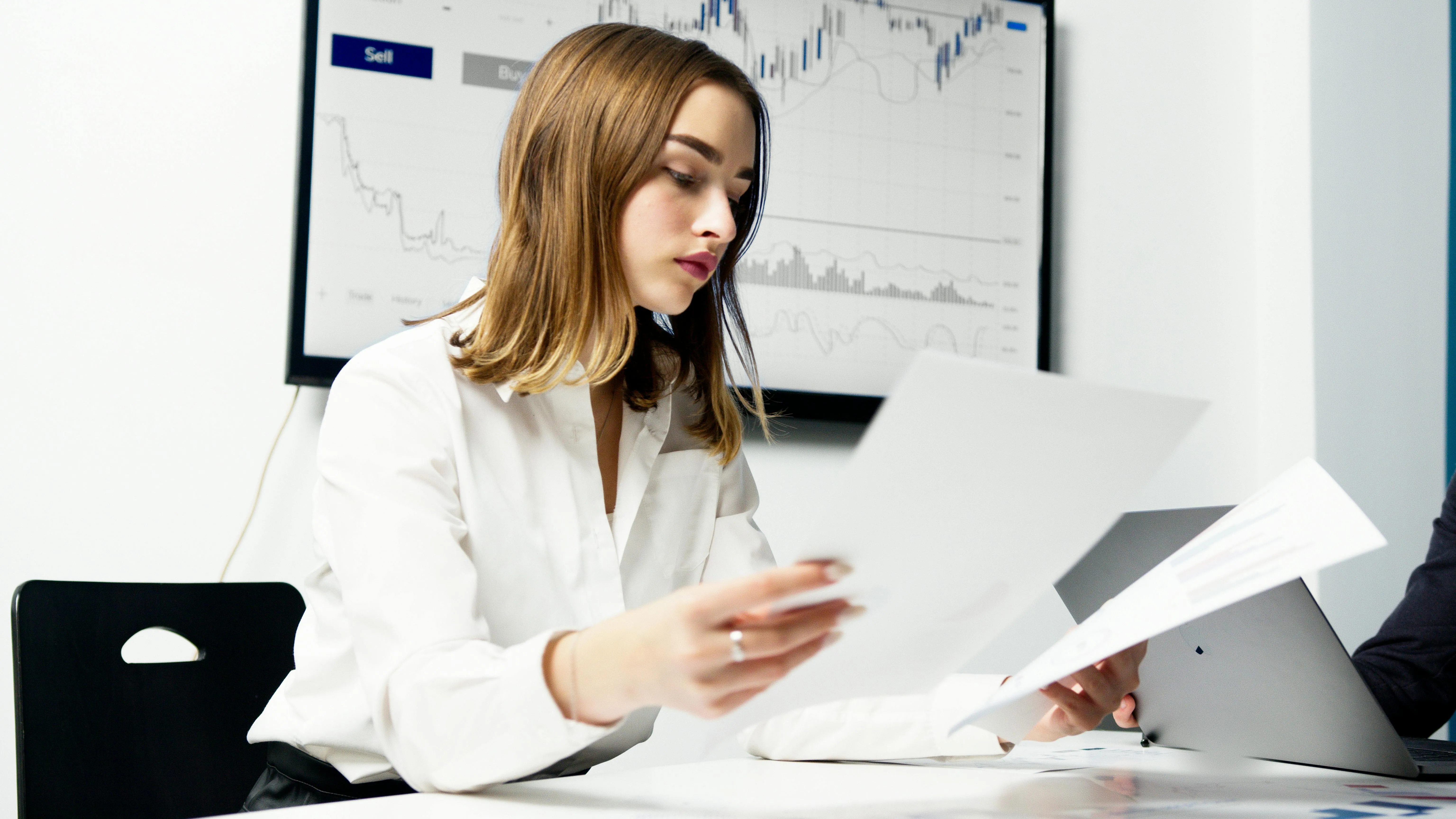 External auditor reviewing client financial statements and audit workpapers at a desk — choosing an MoE-accredited audit firm in Dubai for mainland, DIFC, DMCC and free zone entities in 2026