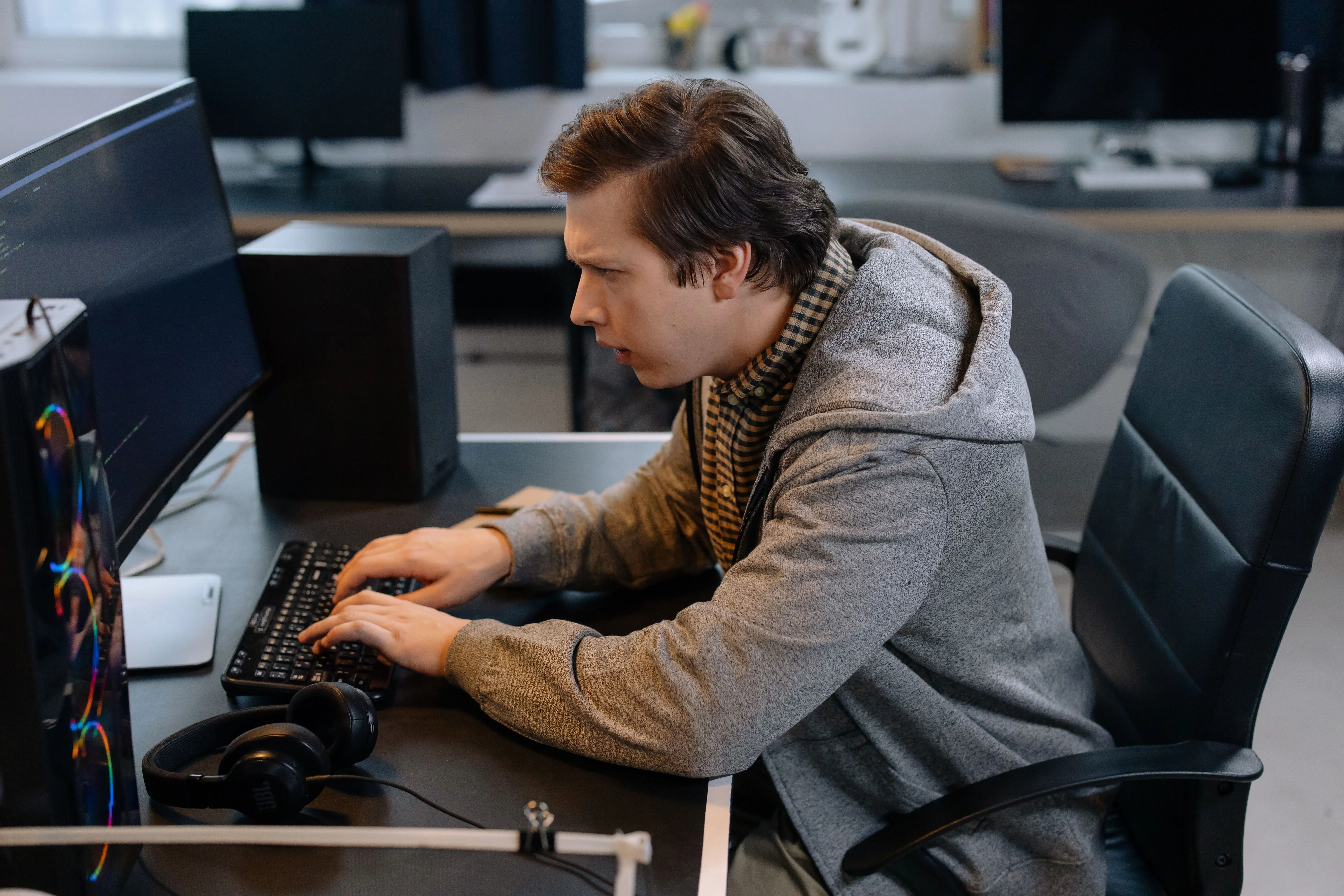 Professional on a desk phone alongside laptop — reaching the UAE Federal Tax Authority through the 600 599 994 hotline, EmaraTax in-portal tickets, email and branch service centres