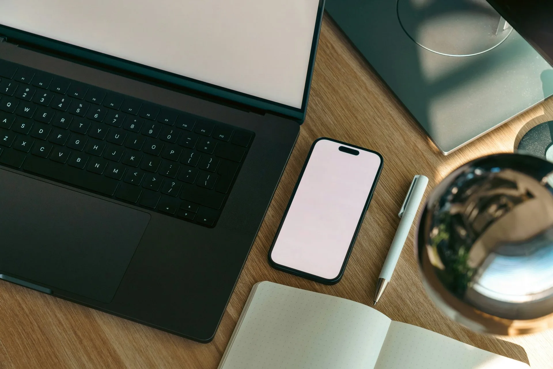 Velmont Crest accounting workspace — laptop, phone and notebook for UAE SME industry bookkeeping