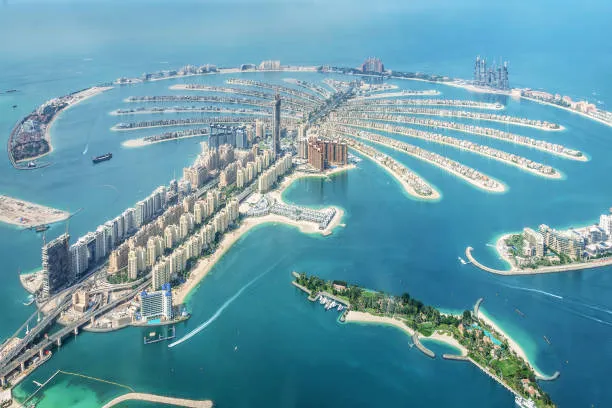 International business waterfront skyline — JAFZA Offshore, RAK ICC and Ajman Offshore holding-structure setup, IP protection and cross-border asset planning