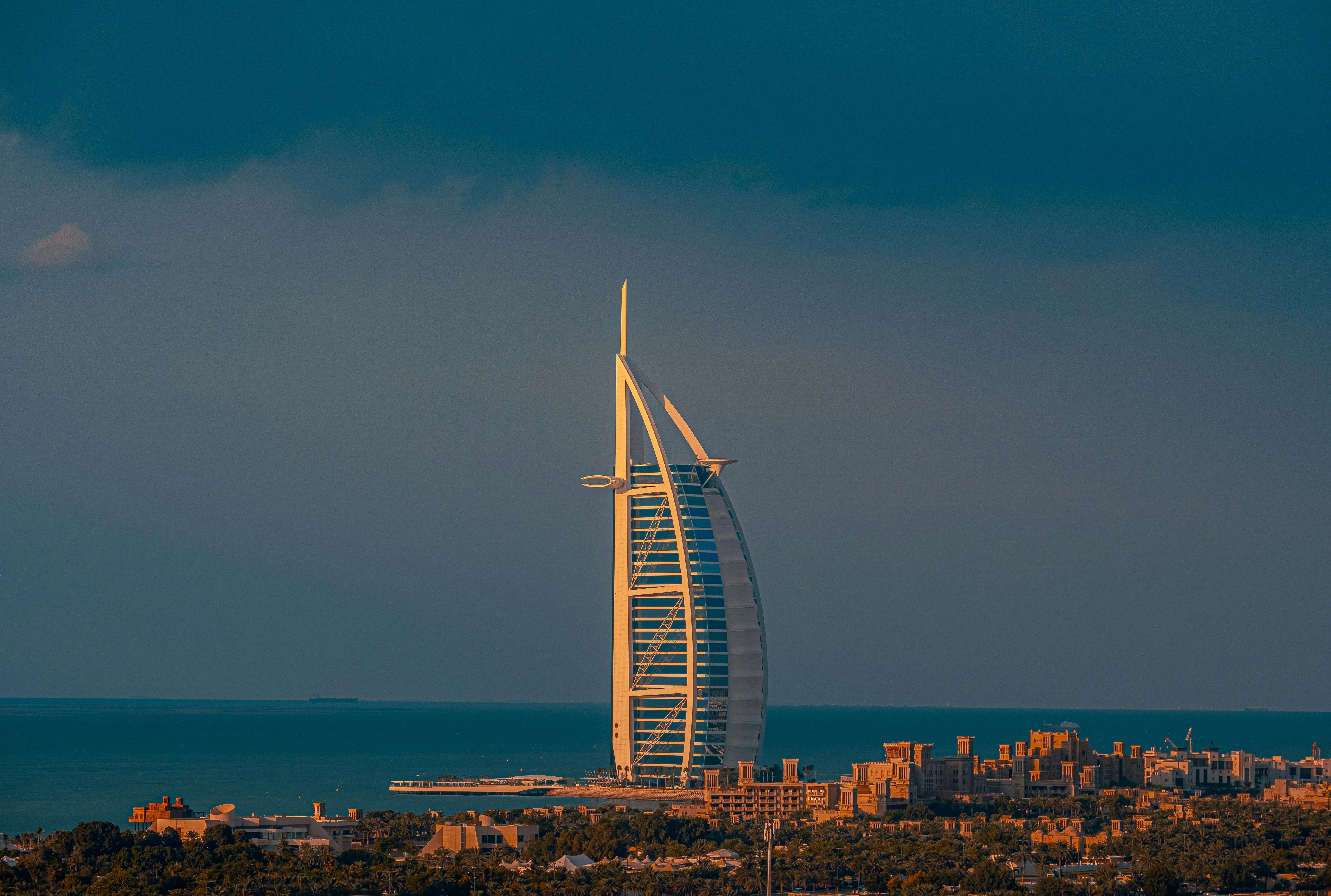 Burj Al Arab at golden hour against a stormy Dubai sky — Velmont Crest UAE accounting and tax insights for Dubai SMEs.