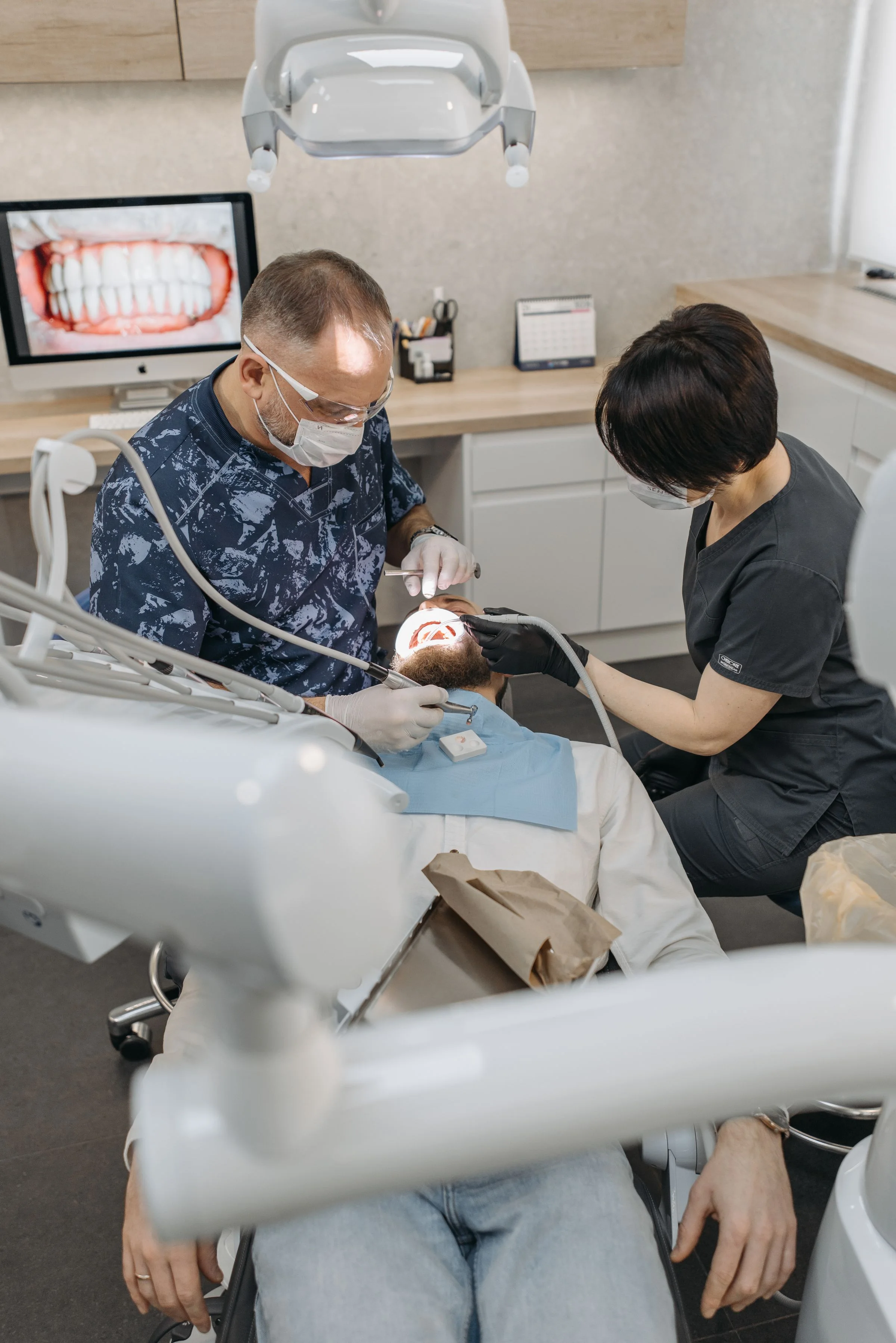 UAE inventor and business owner reviewing a granted patent certificate and technical drawings at a Dubai office