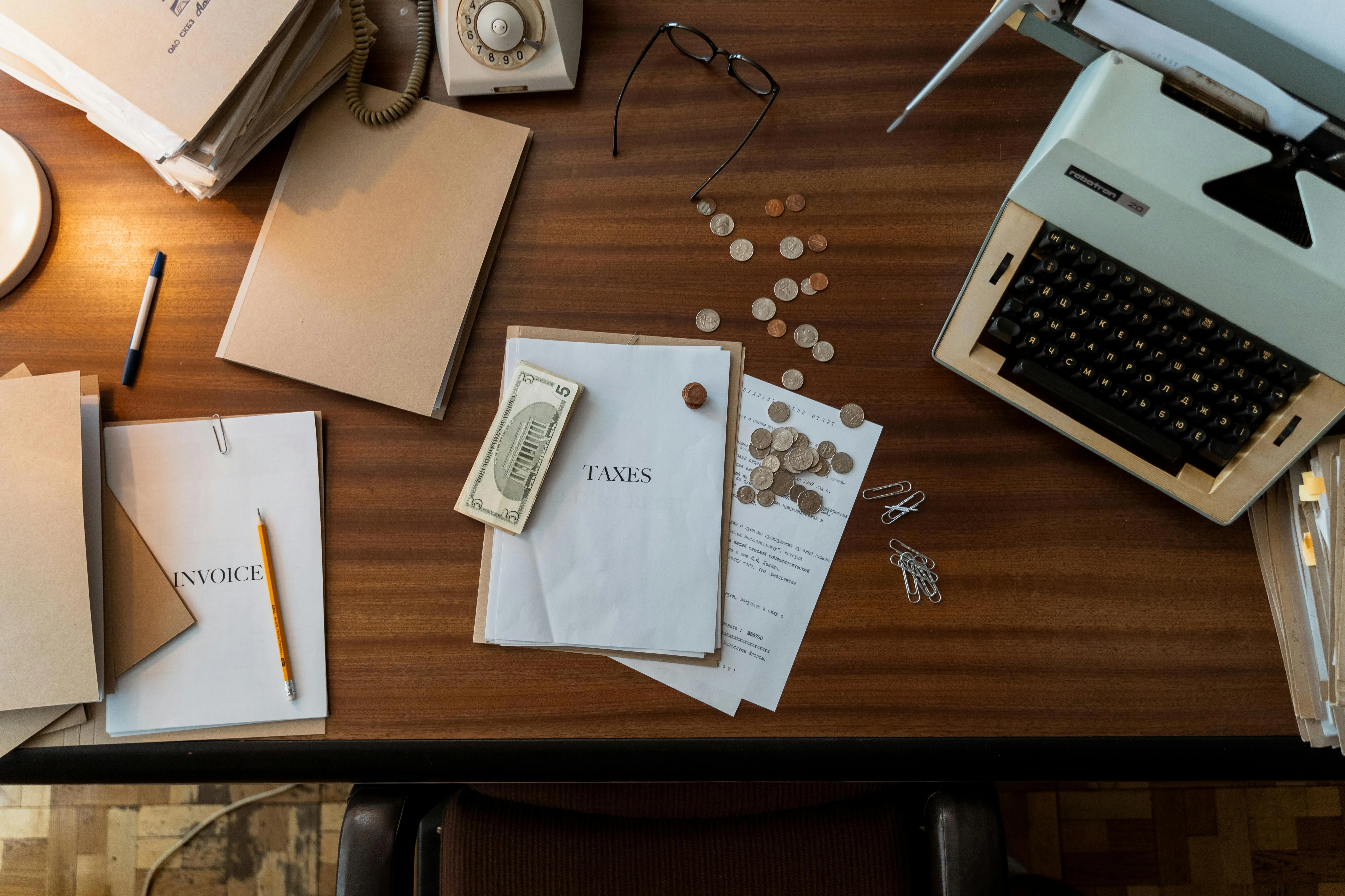 Close-up of UAE Federal Decree-Law 8/2017 VAT documentation and FTA-compliant tax invoices on a Dubai accountant's desk during a Velmont Crest VAT review