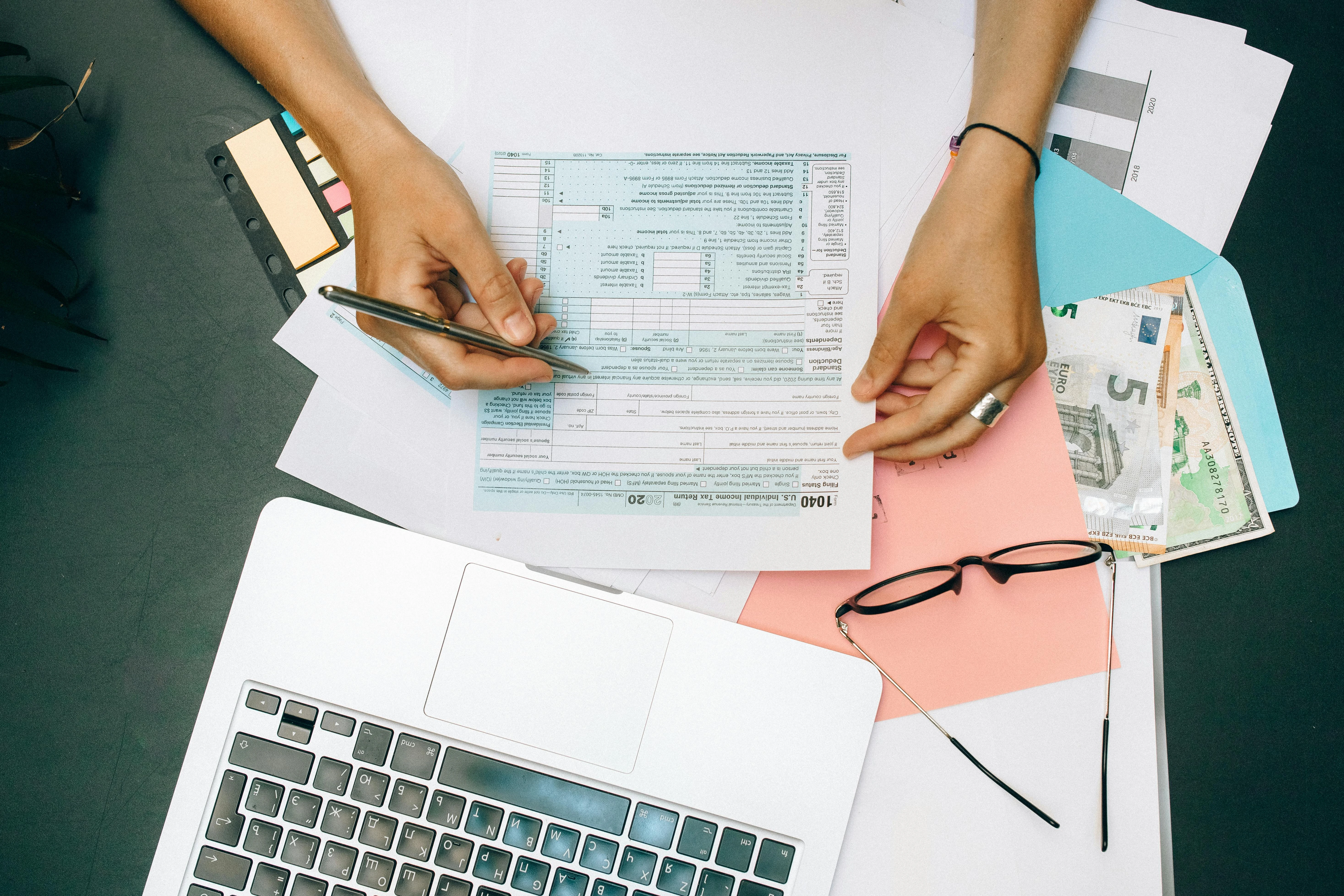 Close-up of audit-ready accounting workpapers and a UAE financial statement file prepared by Velmont Crest for a Dubai SME annual bookkeeping engagement