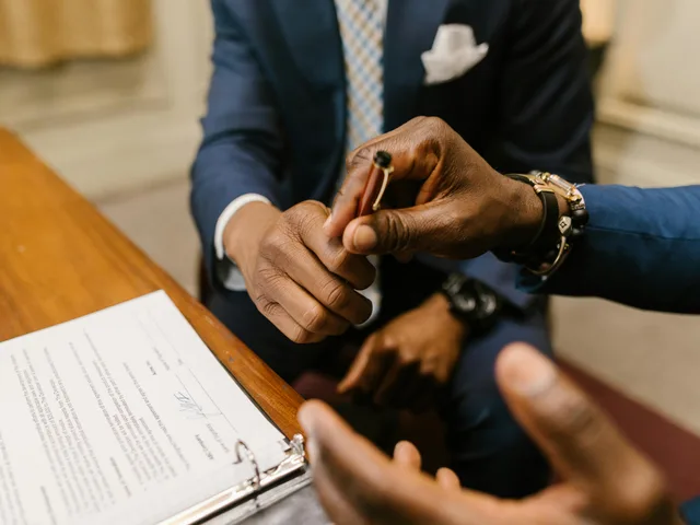 Close-up of a fixed-fee accounting engagement letter being signed between client and advisor.