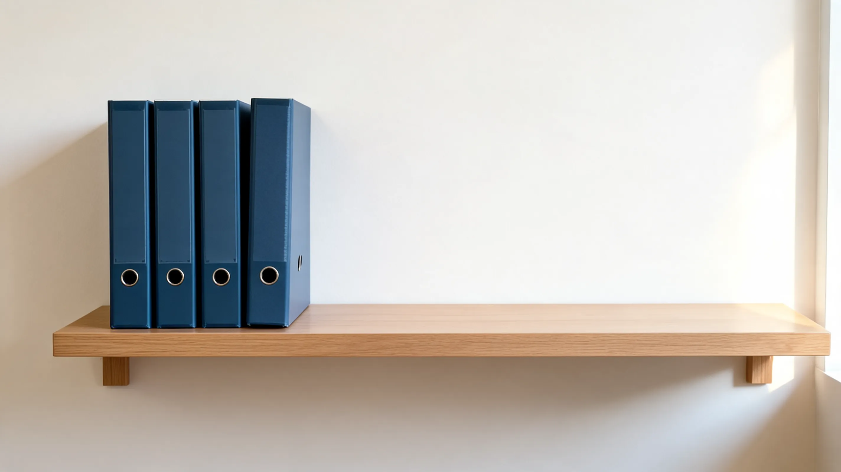 Accounting ledgers filed on an office shelf, the records a trial balance is drawn from before a UAE company's financial statements are prepared