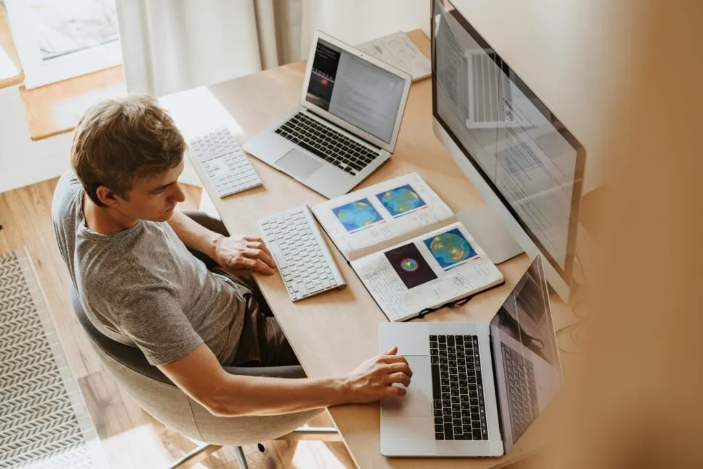 Dubai HR manager updating a remote work employment contract and WPS payroll schedule to meet the 2026 MOHRE work-from-home directive for UAE staff
