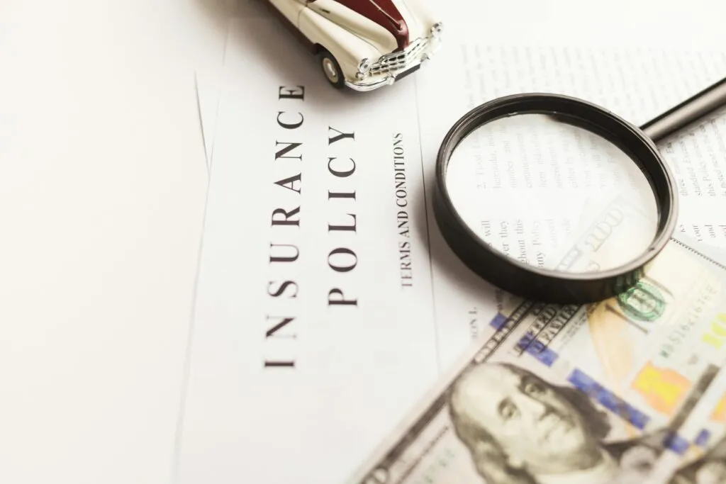 UAE business owner and broker reviewing a commercial insurance policy schedule to identify the standard war-exclusion clause and check separate war risk endorsement options